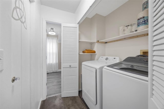 laundry area with dark carpet and washer and dryer