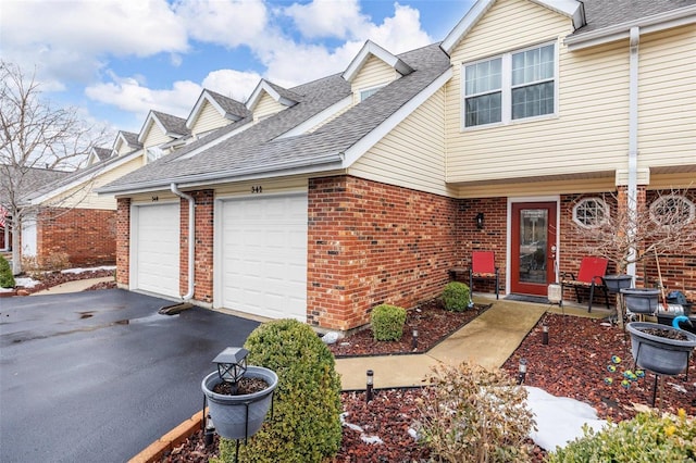 townhome / multi-family property featuring a garage