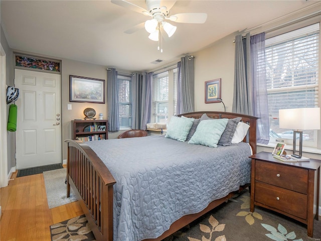 bedroom with light hardwood / wood-style floors and ceiling fan