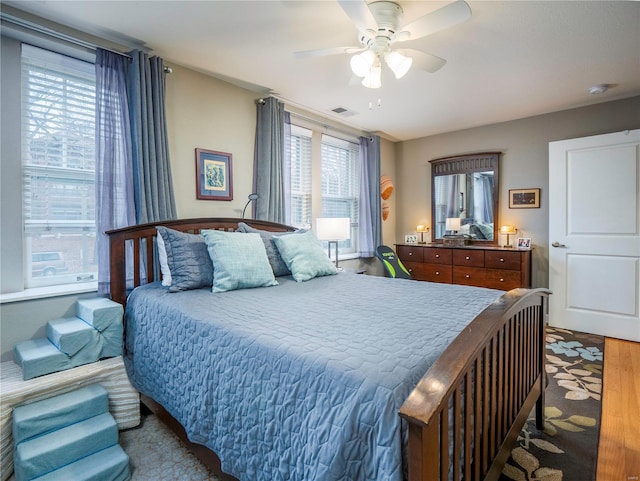 bedroom with wood-type flooring and ceiling fan