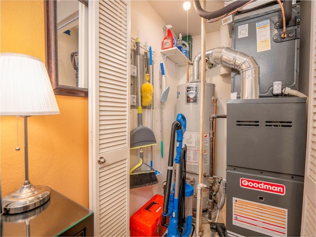 utility room featuring gas water heater and heating unit