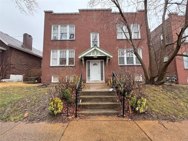 view of front of home featuring brick siding