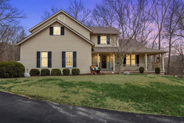 view of front facade with a yard and covered porch