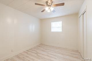 spare room with light hardwood / wood-style flooring and ceiling fan