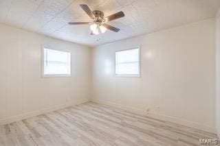 unfurnished room featuring ceiling fan, plenty of natural light, and light wood-type flooring