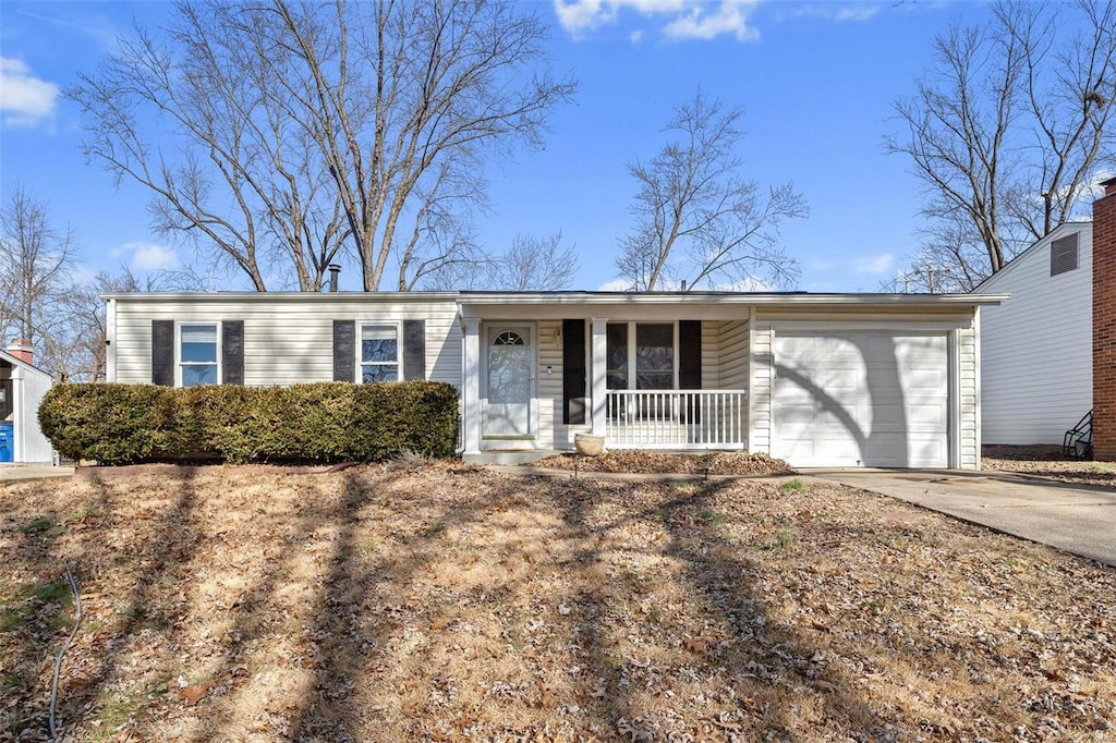 ranch-style house featuring a garage and a porch