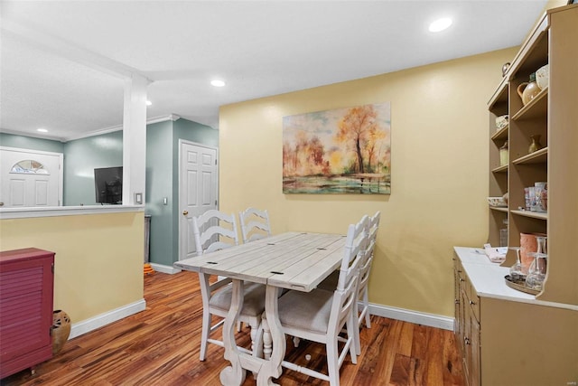 dining space featuring wood-type flooring