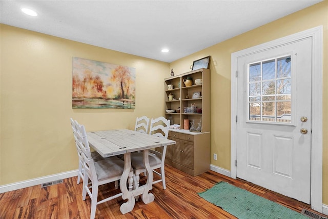 dining space with hardwood / wood-style flooring