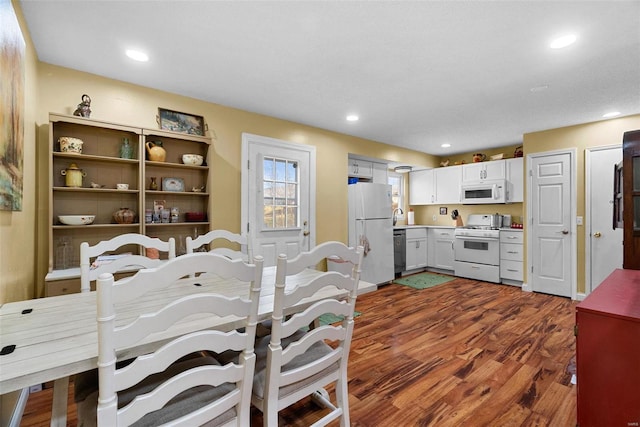 dining area featuring dark wood-type flooring