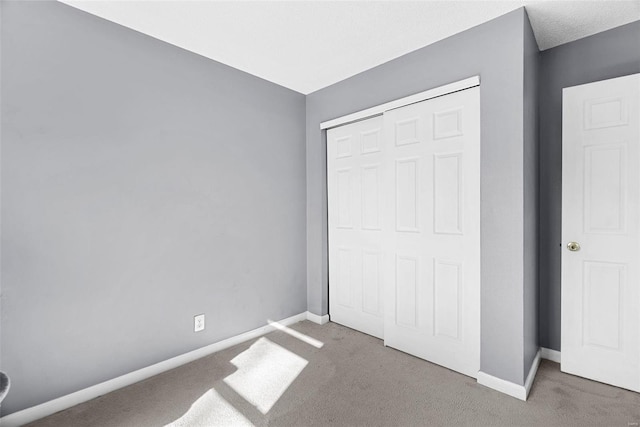 unfurnished bedroom with a closet and carpet