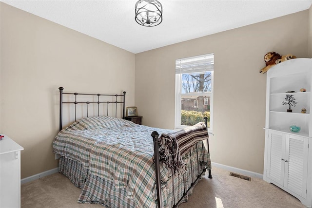 bedroom with light colored carpet