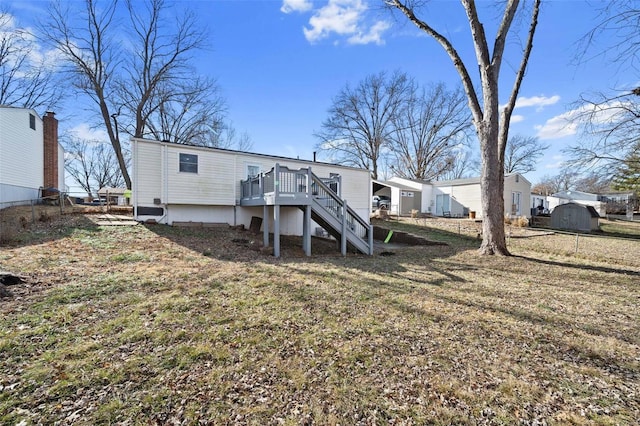 back of property featuring a yard and a deck