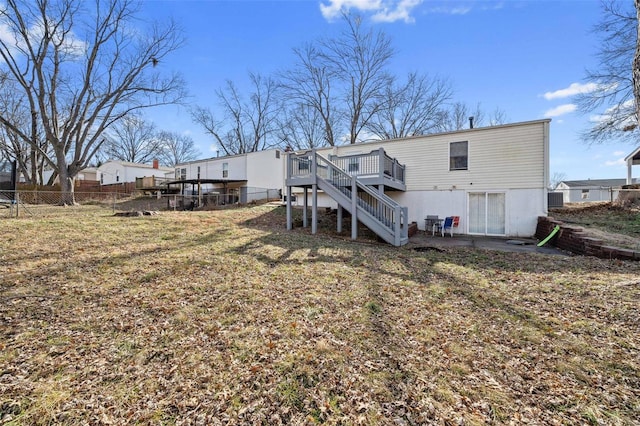 back of property featuring a yard and a deck