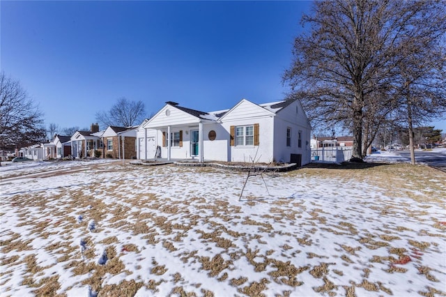 view of front of property with a residential view and fence