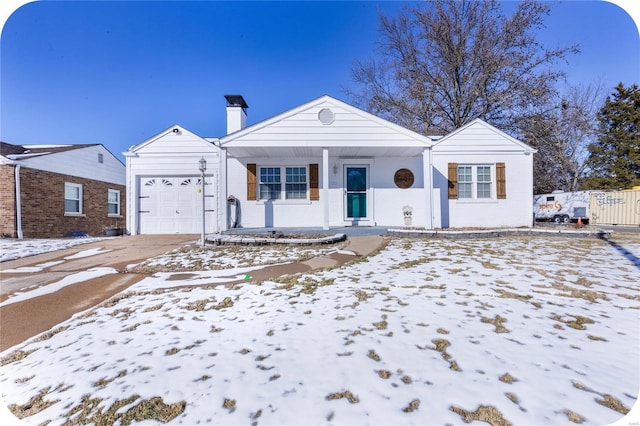 ranch-style home with a porch, a chimney, and an attached garage