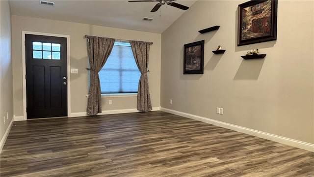 foyer entrance featuring dark wood-type flooring, a wealth of natural light, ceiling fan, and vaulted ceiling