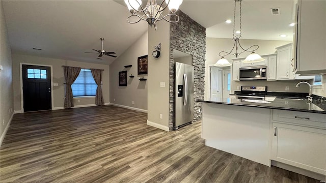 kitchen featuring stainless steel appliances, white cabinetry, sink, and decorative light fixtures