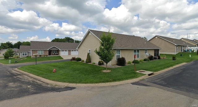 single story home featuring a garage and a front yard