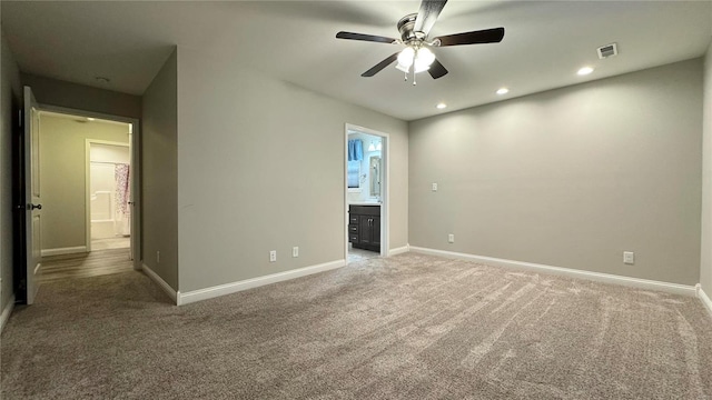 carpeted empty room featuring ceiling fan