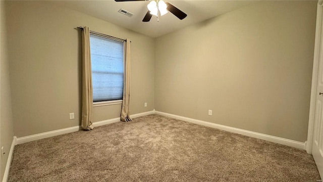 empty room with ceiling fan and light carpet