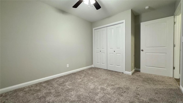 unfurnished bedroom featuring ceiling fan, light colored carpet, and a closet