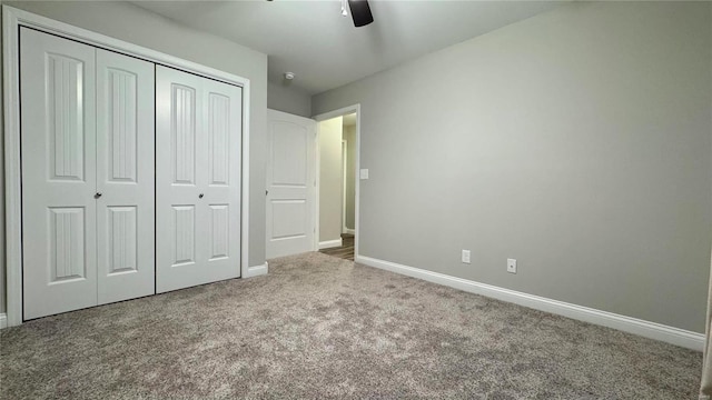 unfurnished bedroom with ceiling fan, carpet floors, and a closet