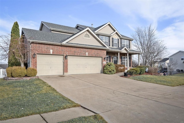 view of front facade featuring a garage, a front yard, and covered porch