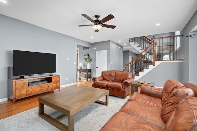 living room with ceiling fan and light hardwood / wood-style flooring