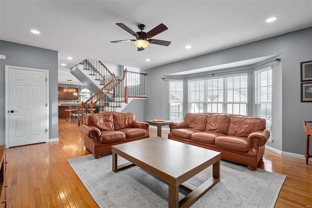 living room with ceiling fan and light hardwood / wood-style floors