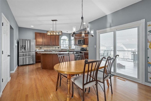 dining space with light hardwood / wood-style floors