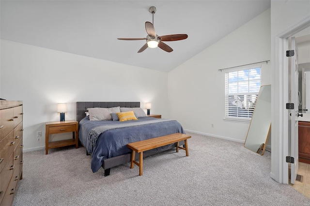 carpeted bedroom with ceiling fan and vaulted ceiling