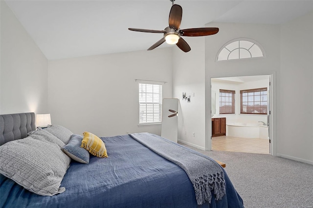 bedroom featuring connected bathroom, light colored carpet, high vaulted ceiling, and ceiling fan