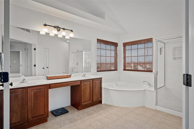 bathroom featuring lofted ceiling, independent shower and bath, and vanity