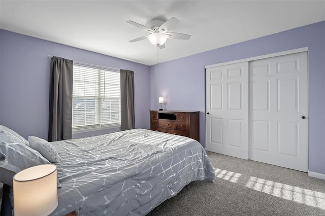 bedroom with ceiling fan, carpet flooring, and a closet