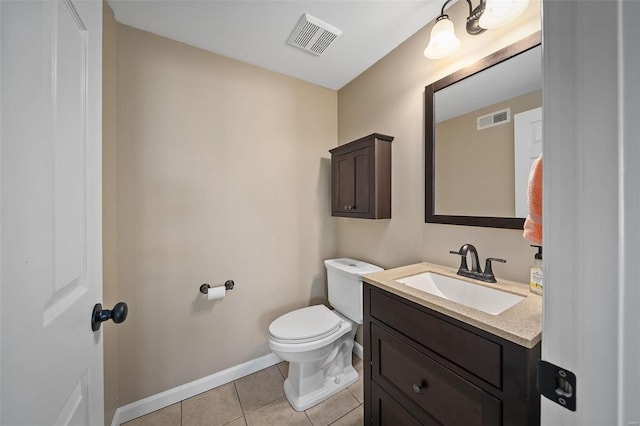 bathroom featuring vanity, toilet, and tile patterned flooring