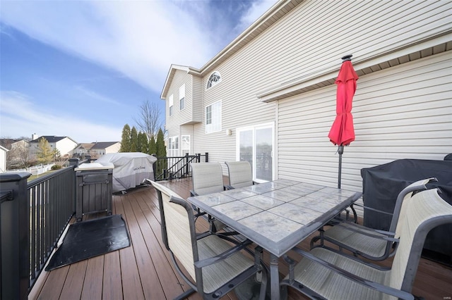 wooden terrace featuring a grill