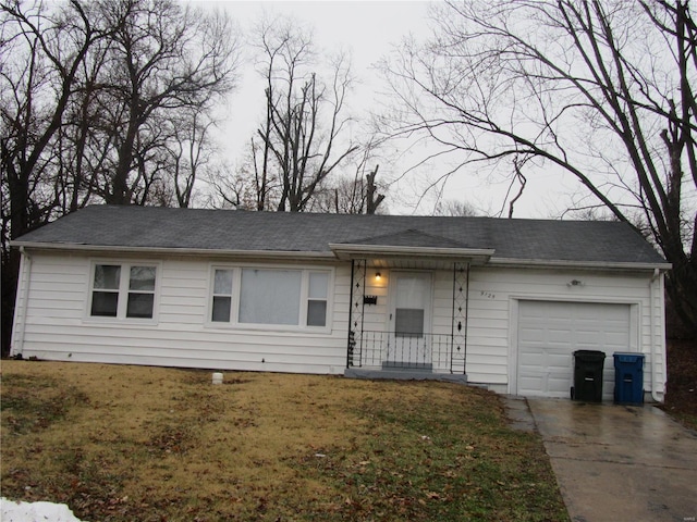 ranch-style house featuring a garage and a front yard