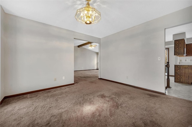 unfurnished room with lofted ceiling, ceiling fan with notable chandelier, and carpet floors