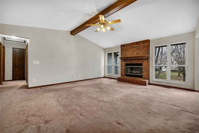 unfurnished living room featuring lofted ceiling with beams, a brick fireplace, carpet floors, and ceiling fan