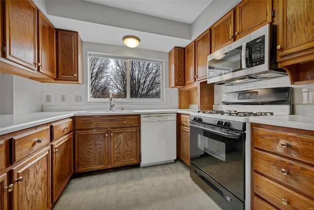 kitchen featuring sink, dishwasher, gas stove, and decorative backsplash