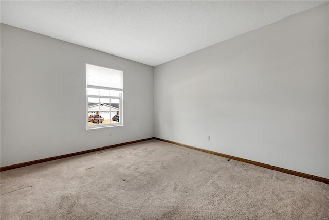 spare room with carpet floors and a textured ceiling