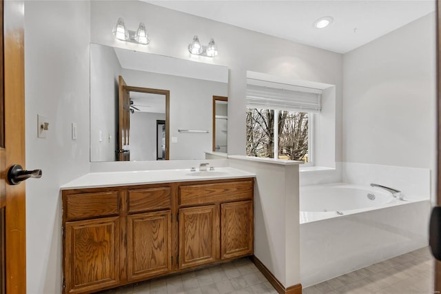 bathroom featuring vanity and a washtub