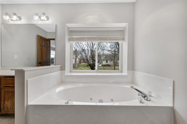 bathroom featuring vanity and a tub