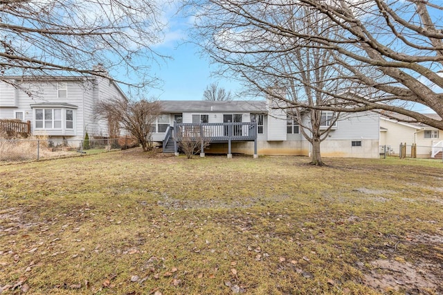 back of house featuring a yard and a deck