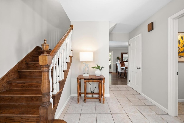 staircase featuring tile patterned flooring