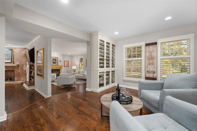 living room featuring dark hardwood / wood-style flooring and ornamental molding