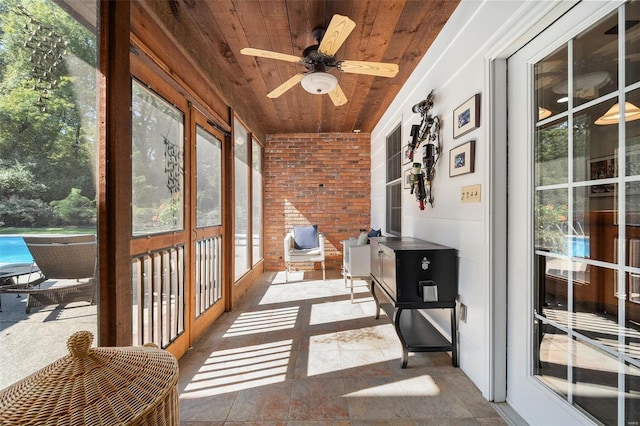 sunroom featuring wooden ceiling and ceiling fan