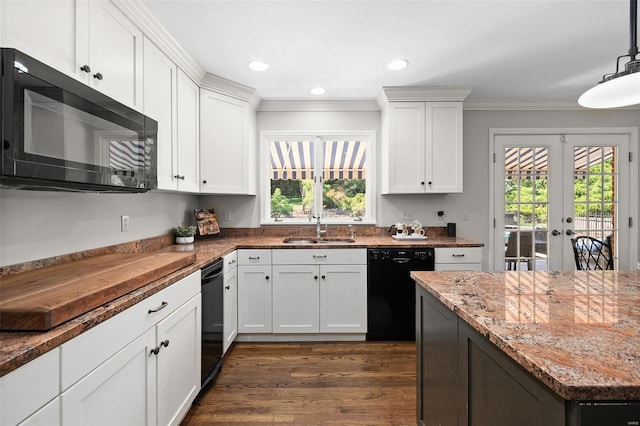 kitchen featuring white cabinetry, sink, black appliances, and hanging light fixtures