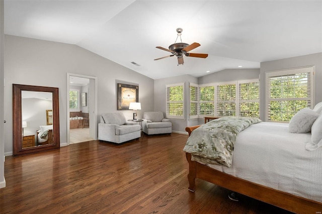 bedroom featuring vaulted ceiling, dark wood-type flooring, ensuite bathroom, and ceiling fan