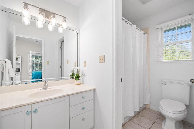 bathroom with vanity, tile patterned floors, and toilet